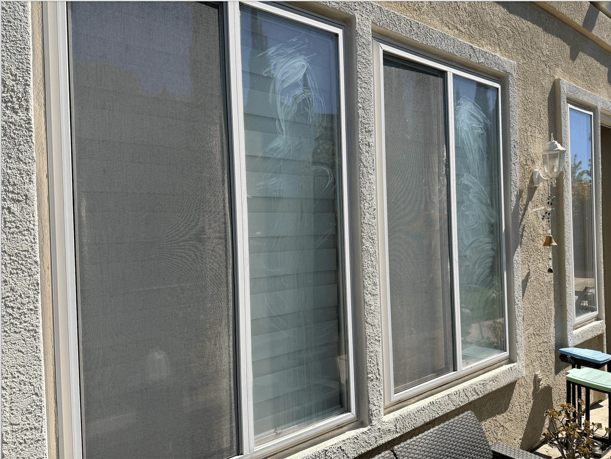 Before: exterior window glass clouded with dried spotting and smears.