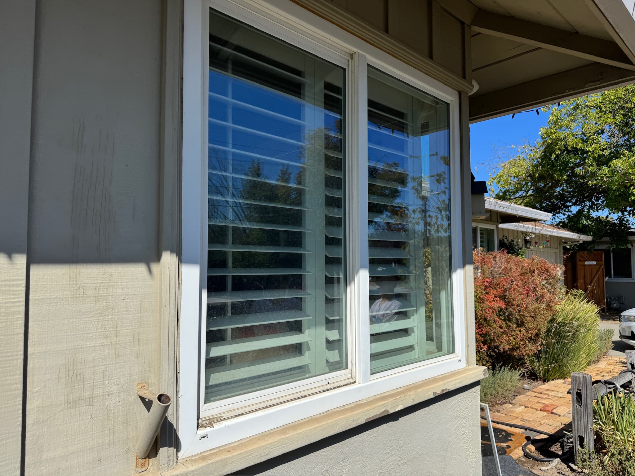 Before: exterior window glass clouded with dried spotting and smears.